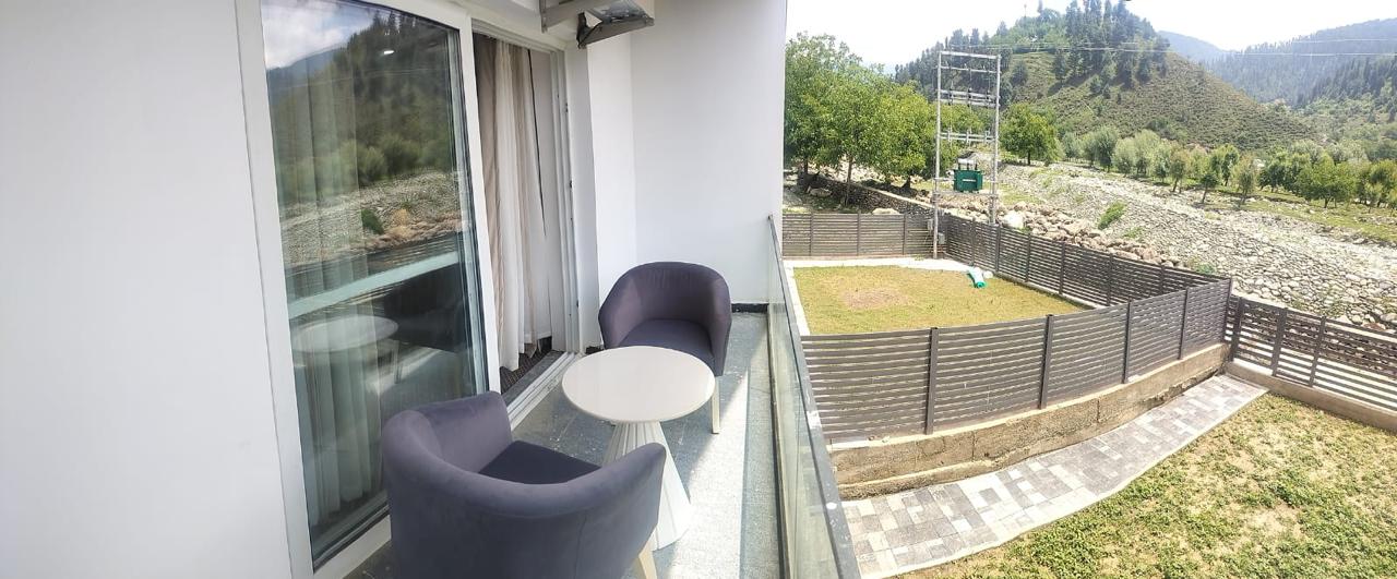 Balcony chairs and table overlooking the grounds
